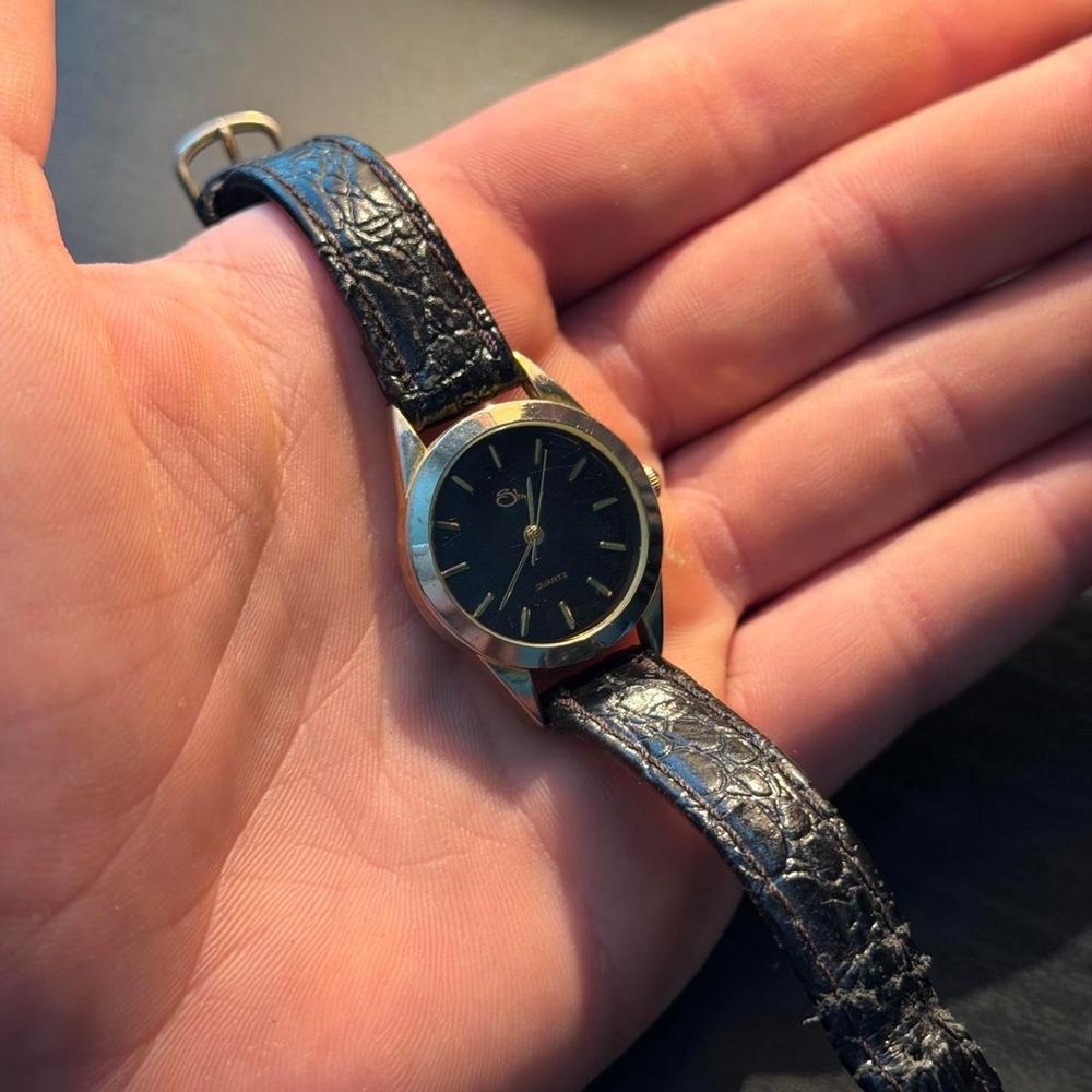 Black womans quartz genuine black leather watch with gold accents and black dial